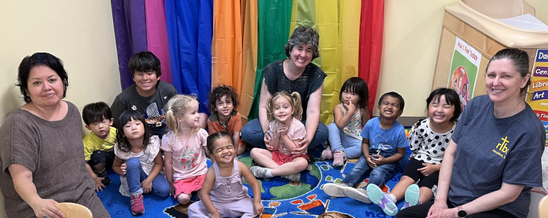 Kids and teachers sitting and smiling