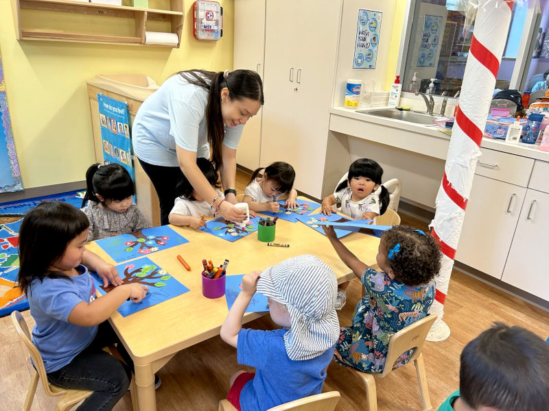 Kids making artwork around a table